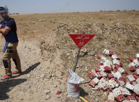 An Iraqi mine clearer working for Halo Trust, a non-profit organization specialized in mine removal, scans an industrial field on August 25, 2019 near Iraqs Baiji, an oil-rich region ravaged by fighting against the Islamic State group in 2014. - IS planted hundreds of improvised explosive devices as a defensive mechanism in fields around Baiji, which the Halo Trust is still working to remove today. (Photo by SABAH ARAR / AFP)        (Photo credit should read SABAH ARAR/AFP via Getty Images)